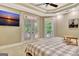 Bright main bedroom featuring a tray ceiling, ceiling fan, and balcony access at 120 Hamilton Glen Ct, Fayetteville, GA 30215
