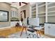 Well-lit office space with built-in shelving and a stylish glass desk at 120 Hamilton Glen Ct, Fayetteville, GA 30215