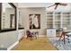 Office boasts built-in shelving, cabinets and natural lighting with adjacent wet bar at 120 Hamilton Glen Ct, Fayetteville, GA 30215
