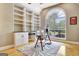 Bright home office with vaulted ceiling, built-in shelving, and an arched window at 120 Hamilton Glen Ct, Fayetteville, GA 30215