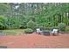 Brick patio with outdoor furniture, trees, and a lush yard at 120 Hamilton Glen Ct, Fayetteville, GA 30215