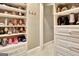 Organized walk-in closet featuring shelves, drawers, and racks for efficient storage of shoes and accessories at 120 Hamilton Glen Ct, Fayetteville, GA 30215