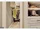 Well-organized walk-in closet with custom shelves, drawers, and ample storage space for clothes and accessories at 120 Hamilton Glen Ct, Fayetteville, GA 30215