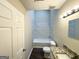 Updated bathroom with granite countertop, tiled shower over tub, and new fixtures offers modern comfort at 4162 Mercer Rd, Decatur, GA 30035