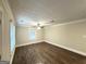 An empty bedroom showcasing sleek, dark wood-look floors, neutral walls, and updated ceiling fan at 4162 Mercer Rd, Decatur, GA 30035
