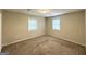 Bright bedroom with neutral walls, carpet, and two windows, providing a serene and inviting space at 4162 Mercer Rd, Decatur, GA 30035