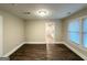 This open living room boasts sleek, dark wood-look floors and a doorway looking into another room at 4162 Mercer Rd, Decatur, GA 30035