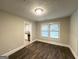 Bright living room featuring sleek, dark wood-look floors and a doorway looking into the kitchen at 4162 Mercer Rd, Decatur, GA 30035