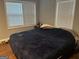 A bright bedroom features a large bed and wood floors at 3479 Thompson Nw Dr, Atlanta, GA 30331