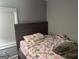 Bedroom with natural light from window; queen sized bed with brown headboard at 3479 Thompson Nw Dr, Atlanta, GA 30331