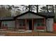Close up of the exterior of a single-story home with grey siding and red accent columns at 3479 Thompson Nw Dr, Atlanta, GA 30331