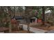 Quaint single-story home with a cozy porch and a red fence surrounding the property at 3479 Thompson Nw Dr, Atlanta, GA 30331