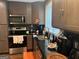 Modern kitchen features sleek countertops, dark cabinets and stainless steel appliances at 3479 Thompson Nw Dr, Atlanta, GA 30331