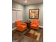 Comfortable living room with hardwood floors, two bright orange armchairs and a decorative rug at 3479 Thompson Nw Dr, Atlanta, GA 30331