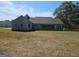 Rear elevation of a home showing a covered back porch and spacious yard at 1685 Crumbley Rd # 4, Mcdonough, GA 30252