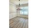Bright dining room with wood floors, wainscotting and a modern chandelier at 1685 Crumbley Rd # 4, Mcdonough, GA 30252