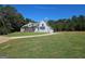 Sprawling front lawn of this home featuring light-blue siding and lovely landscaping at 1685 Crumbley Rd # 4, Mcdonough, GA 30252