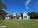 Charming two-story home with a well-manicured lawn under a bright, clear sky at 1685 Crumbley Rd # 4, Mcdonough, GA 30252