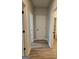 Hallway featuring wood floors with doors to rooms at 1685 Crumbley Rd # 4, Mcdonough, GA 30252