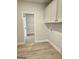 Laundry room with vinyl flooring, white cabinets and door to walk-in closet at 1685 Crumbley Rd # 4, Mcdonough, GA 30252
