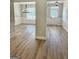 Open living space with wood floors and a view into the dining area and entry at 1685 Crumbley Rd # 4, Mcdonough, GA 30252