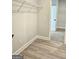 Walk-in closet featuring luxury vinyl floors and wire shelving system at 1685 Crumbley Rd # 4, Mcdonough, GA 30252