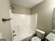 Bright bathroom features a shower and tub combo with white fixtures and neutral walls at 9151 Jefferson Village Sw Dr, Covington, GA 30014