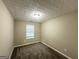 Simple bedroom featuring plush carpet, neutral paint, and natural light from window at 9151 Jefferson Village Sw Dr, Covington, GA 30014