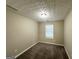 Cozy bedroom featuring neutral paint, plush carpet, and natural light from window at 9151 Jefferson Village Sw Dr, Covington, GA 30014