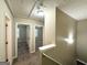 Upstairs hallway with carpet floors and open doorway to a bedroom with natural light at 9151 Jefferson Village Sw Dr, Covington, GA 30014