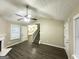 Bright living room featuring a staircase, hardwood floors, and access to the kitchen at 9151 Jefferson Village Sw Dr, Covington, GA 30014