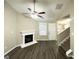 Cozy living room with hardwood floors, fireplace, ceiling fan, and ample natural light at 9151 Jefferson Village Sw Dr, Covington, GA 30014