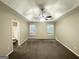 Spacious main bedroom with ceiling fan, plush carpeting, and ensuite bathroom access at 9151 Jefferson Village Sw Dr, Covington, GA 30014