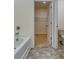 Bathroom featuring tile floors, bathtub, and a view into a walk-in closet with wire shelving at 616 Whitman Ln # 30, Stockbridge, GA 30281