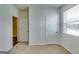 Neutral bedroom with a closed door, and a window providing lots of natural light at 616 Whitman Ln # 30, Stockbridge, GA 30281