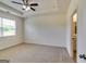 Spacious bedroom featuring neutral carpet, ceiling fan, and natural light from the window at 616 Whitman Ln # 30, Stockbridge, GA 30281