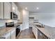 Modern kitchen featuring white cabinets, granite countertops, stainless appliances, and wood floors at 616 Whitman Ln # 30, Stockbridge, GA 30281