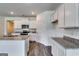 Modern kitchen with white cabinets, granite countertops, stainless appliances, and wood flooring at 616 Whitman Ln # 30, Stockbridge, GA 30281