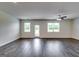 Expansive living room with hardwood floors, recessed lighting, and sliding glass doors to the backyard at 616 Whitman Ln # 30, Stockbridge, GA 30281