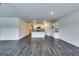 Open-concept living space with wood floors, neutral walls, and a view of the kitchen at 616 Whitman Ln # 30, Stockbridge, GA 30281