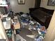 Disheveled bedroom with assorted debris, dated furniture and an old air conditioner at 530 Whitley Dr, Forest Park, GA 30297