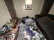 Untidy bedroom featuring a worn couch and littered with a variety of items at 530 Whitley Dr, Forest Park, GA 30297