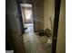 Tiled hallway leading to another room, displaying visible signs of neglect and disrepair at 530 Whitley Dr, Forest Park, GA 30297