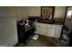 Compact kitchen area featuring essential appliances and cabinetry, ideal for renovation and modern upgrades at 530 Whitley Dr, Forest Park, GA 30297