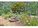 Lush landscaped backyard with a charming pond and colorful flowers surrounding a barn at 104 Whisper Trce, Peachtree City, GA 30269