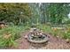 Beautiful backyard featuring a stone waterfall surrounded by lush landscaping, a gardener's delight at 104 Whisper Trce, Peachtree City, GA 30269