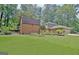 Expansive backyard showing barn, garden, and lawn, offering plenty of space for outdoor activities at 104 Whisper Trce, Peachtree City, GA 30269