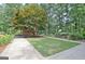 Well-maintained backyard featuring a lush lawn, mature trees, garden, and a barn at 104 Whisper Trce, Peachtree City, GA 30269