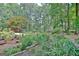 Landscaped backyard with barn, garden and mature trees. A tranquil outdoor space at 104 Whisper Trce, Peachtree City, GA 30269
