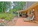 Serene backyard featuring a covered patio, swing, and lush landscaping, perfect for relaxation and entertaining at 104 Whisper Trce, Peachtree City, GA 30269